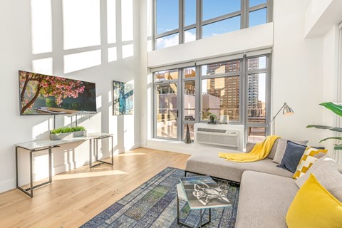 a living room with a couch and a large window